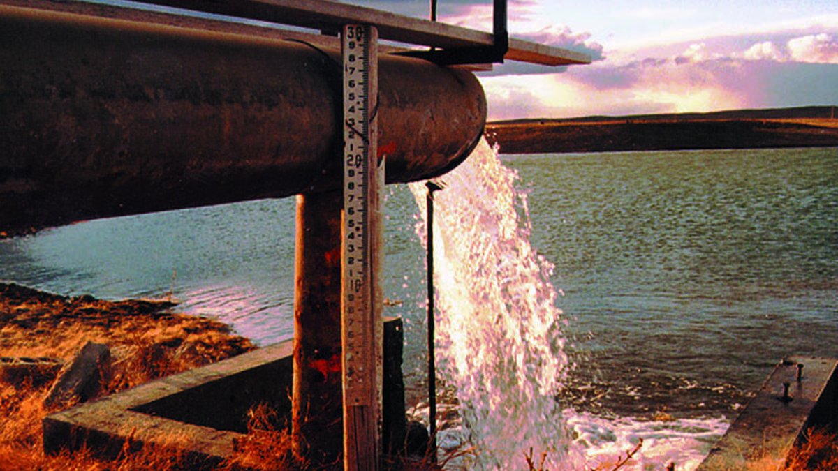 Water flows into ag ditch from pipe