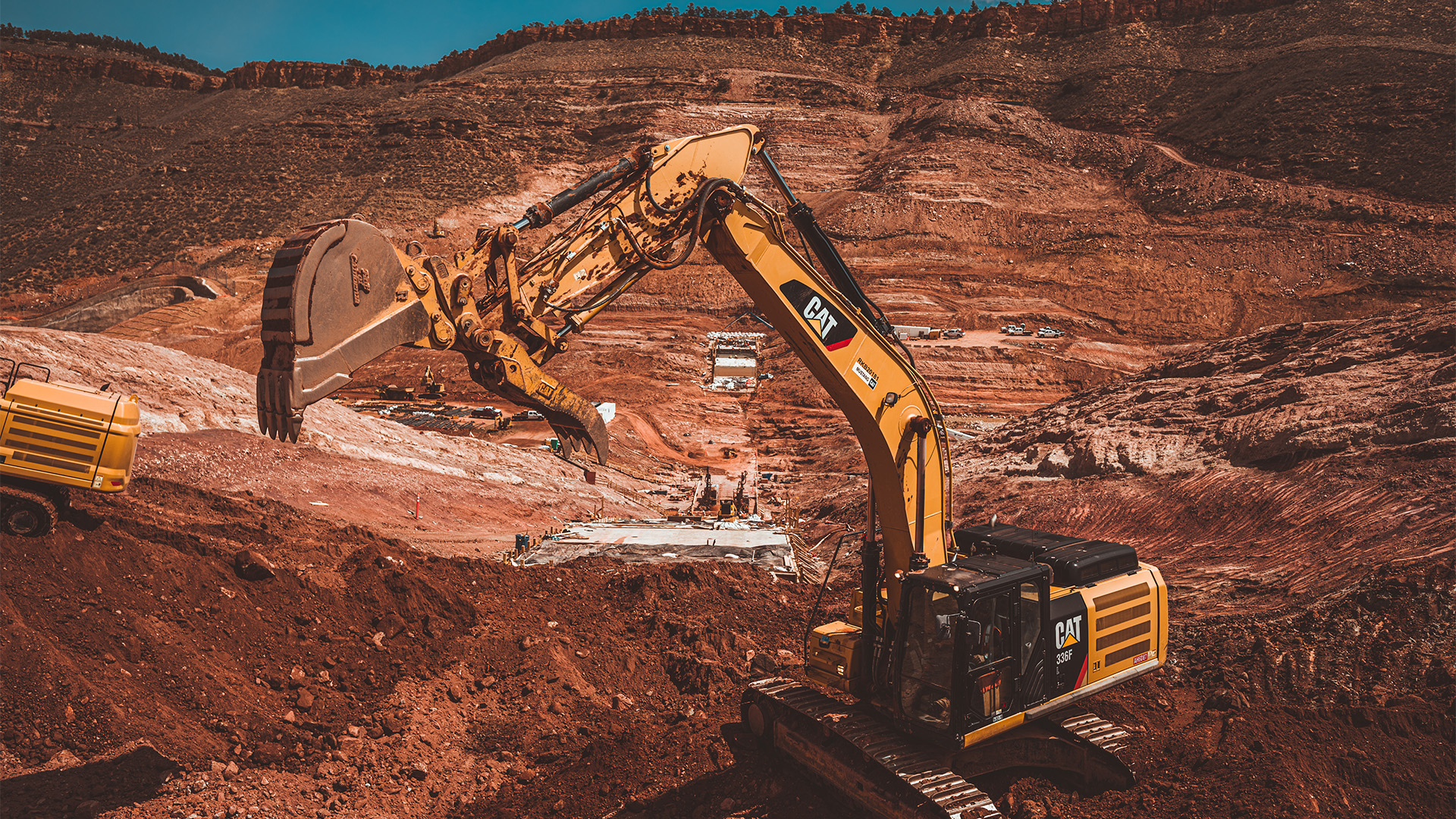 Excavator exacvating the main dam foundation.