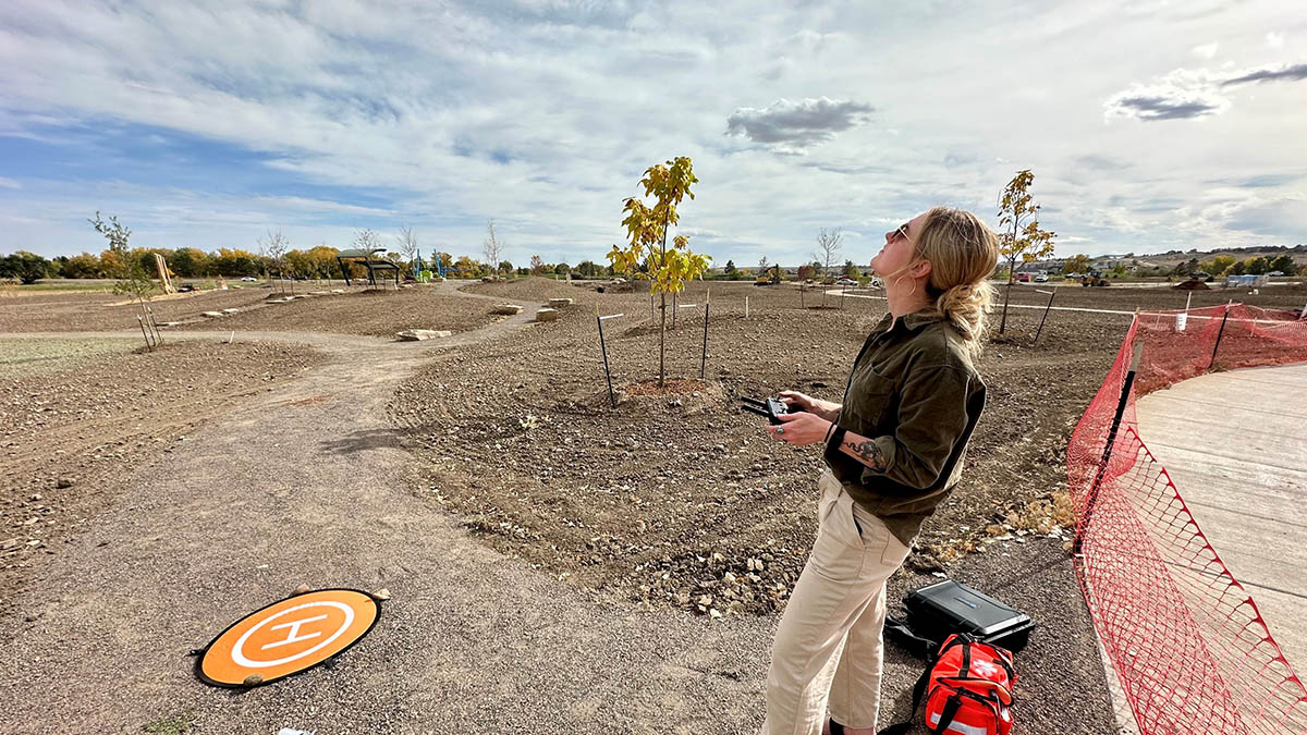 A Northern Water employee and drone pilot flies a drone over the Eastman Park Wetland Experience in 2024