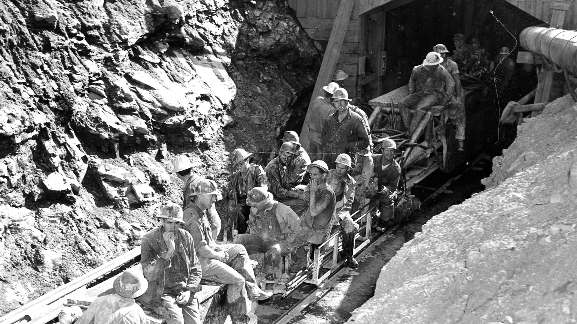 Black and white photo of crews entering the East Portal while constructing the Adams Tunnel in the 1940s