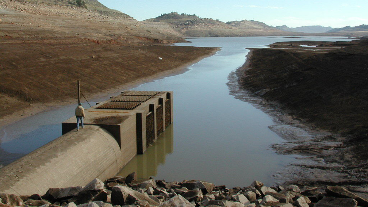 A northern water employee walks on the outlet structure at Horsetooth Reservoir when the water was at very low elevation