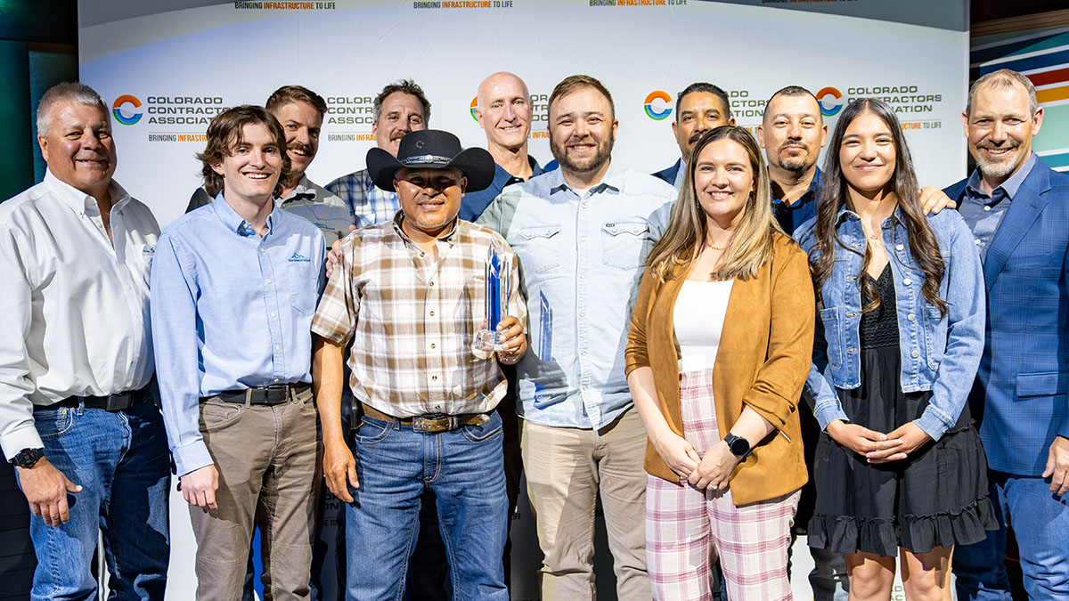 A group of people stand for a picture holding an award.