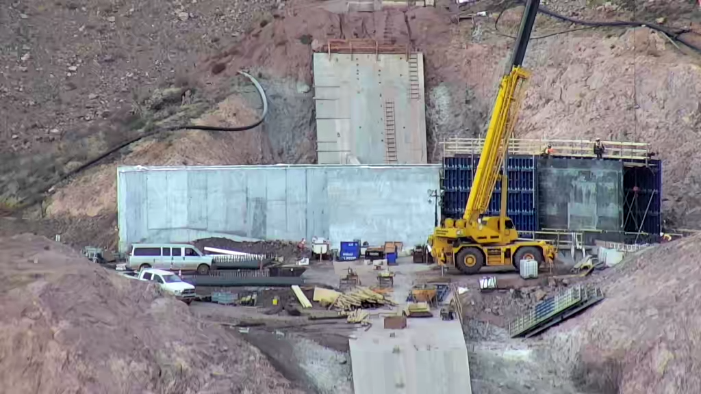 View of the concrete walls that tie the spillway into the main dam on the west abutment.