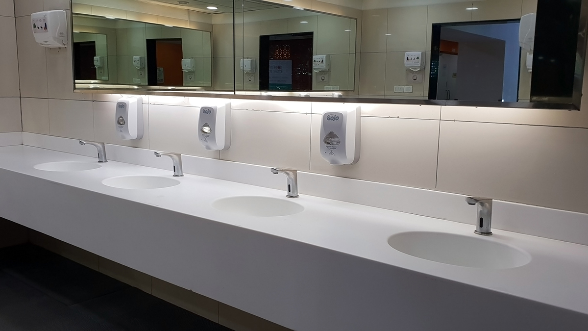 four sinks in a commercial bathroom