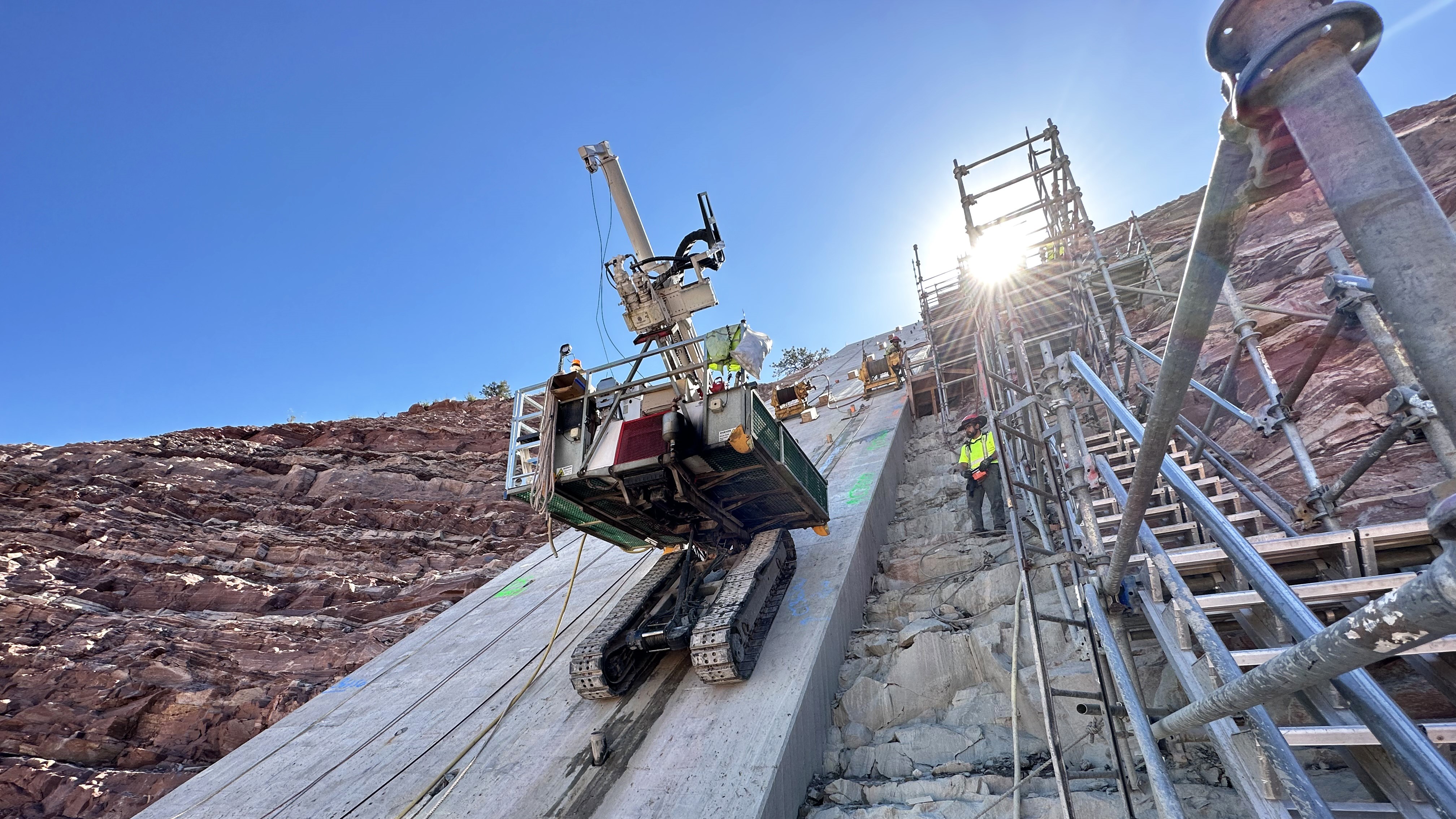 Grouting machine on steep abutment at Chimney Hollow