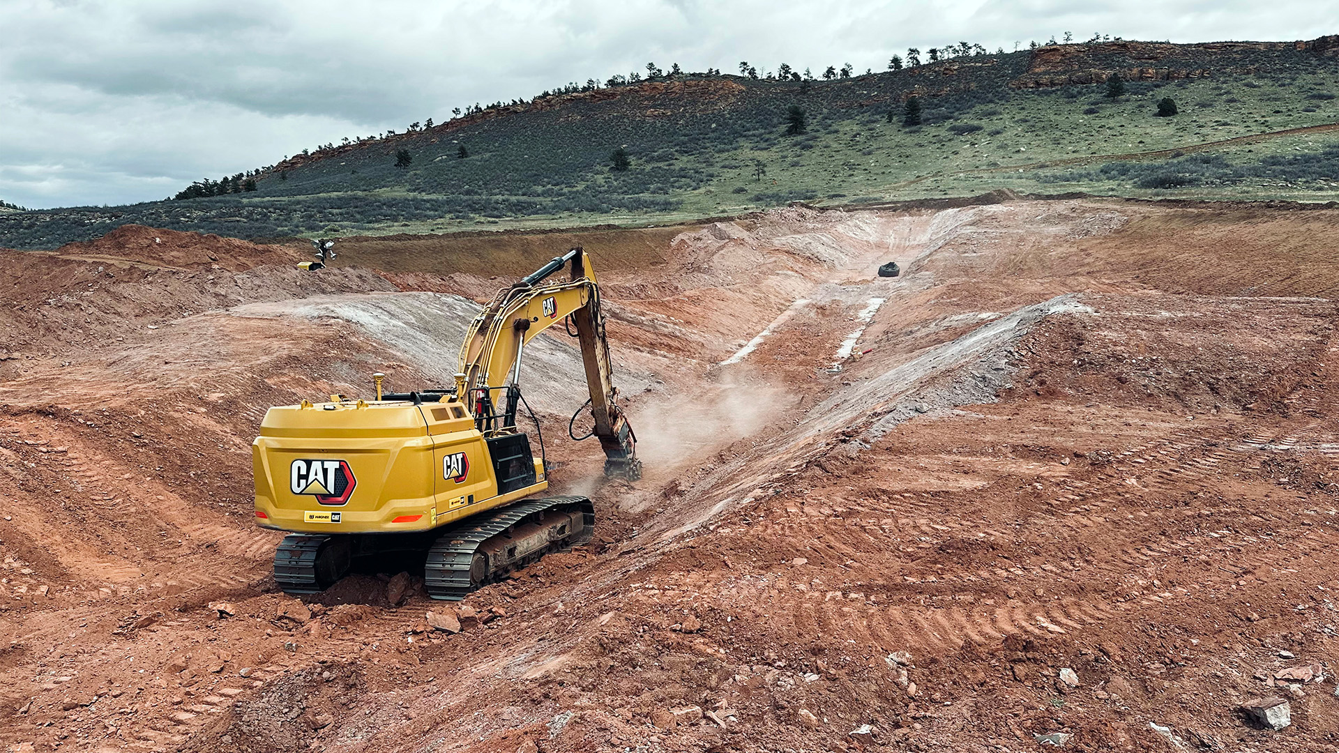 Backhoe working on saddle dam