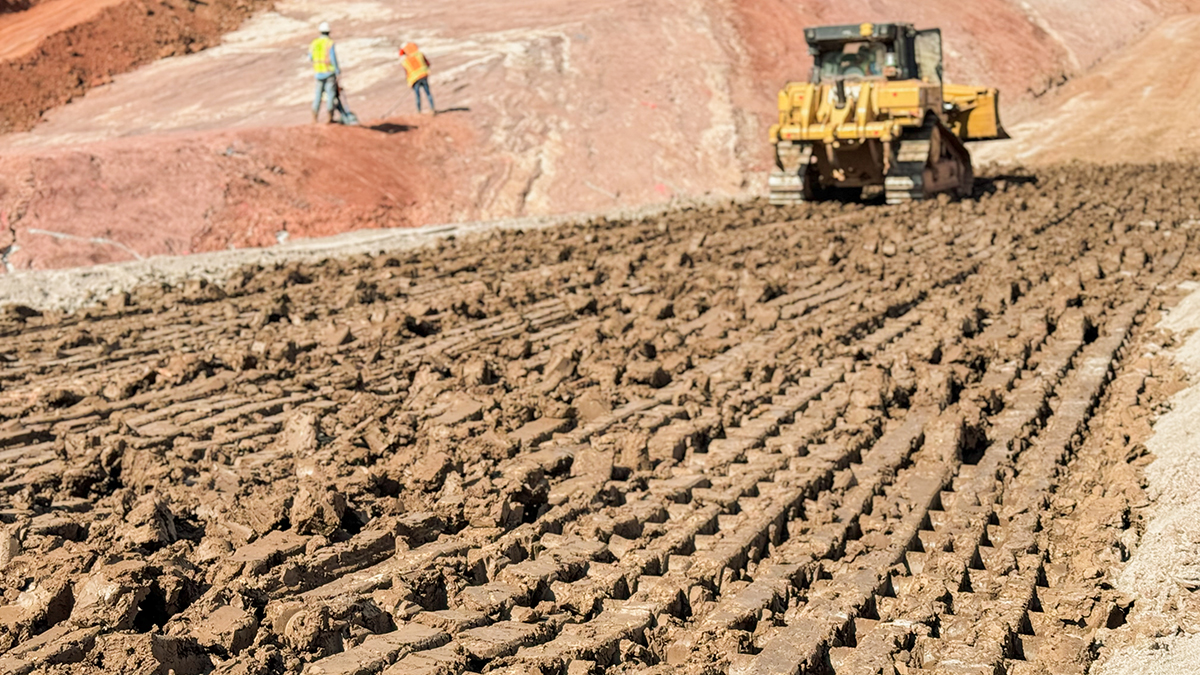 Equipment compacting layers of clay on the Chimney Hollow saddle dam