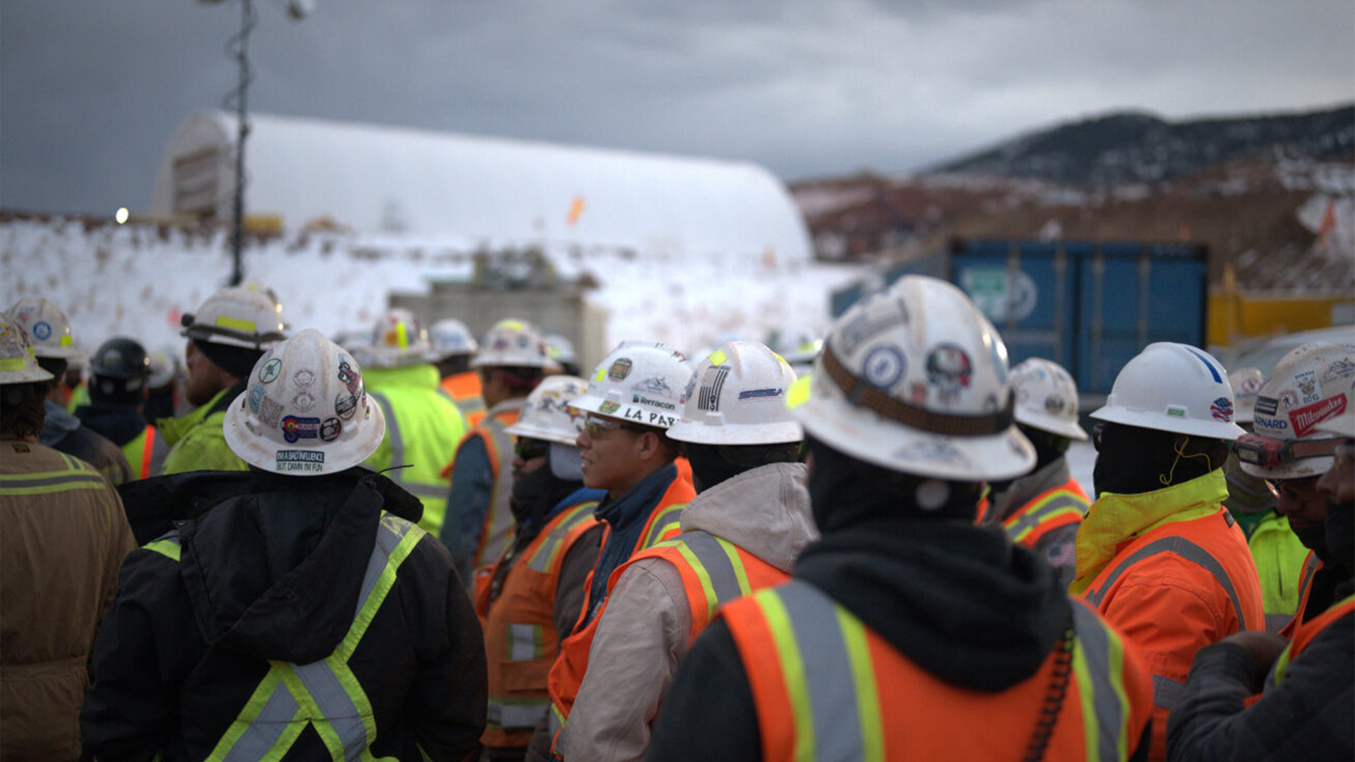 Group of employees at Chimney Hollow listening to a safety meeting during the winter.